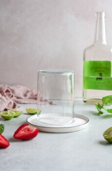 a glass turned upside down onto a dish of salt.