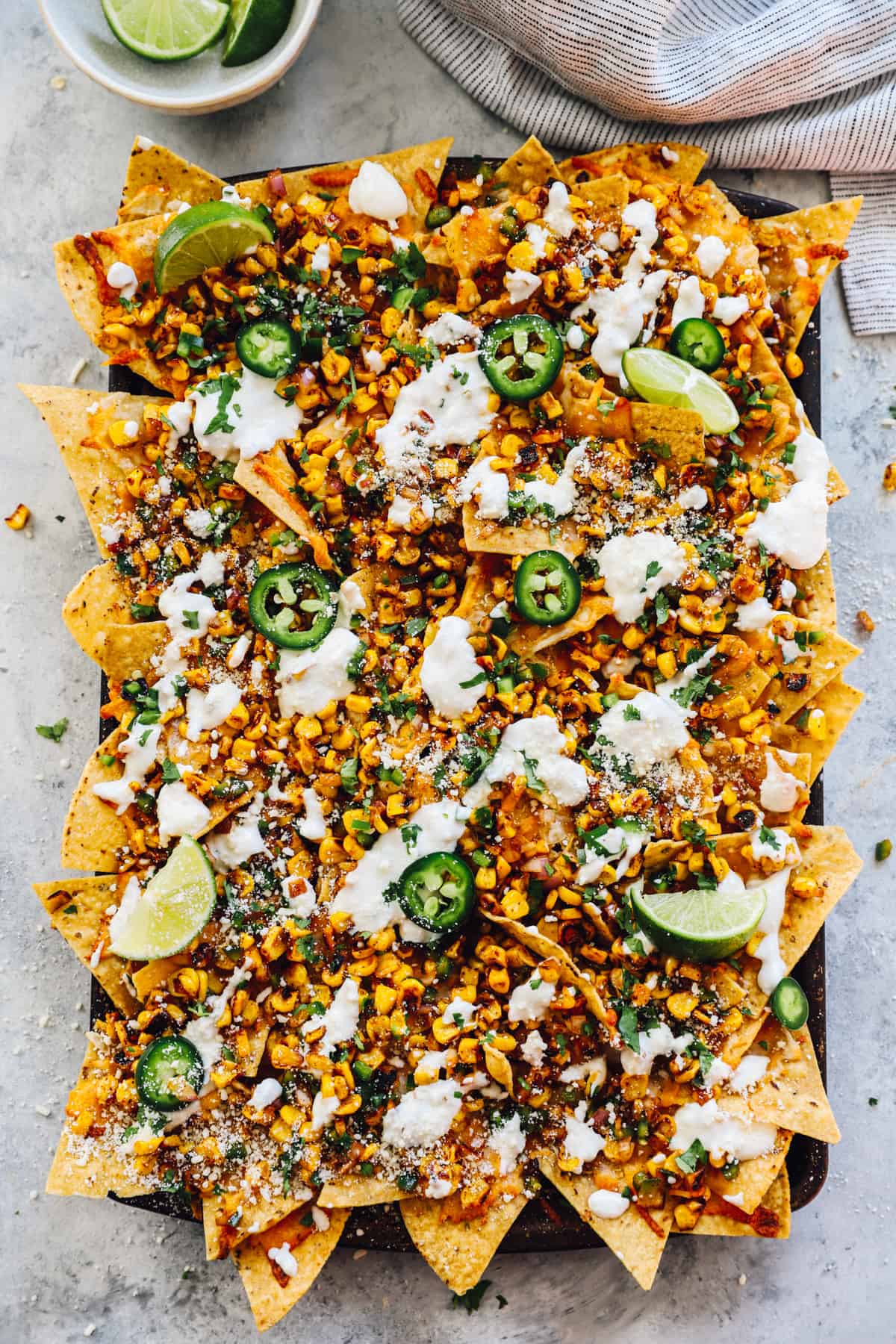 overhead view of street corn nachos on a baking sheet.