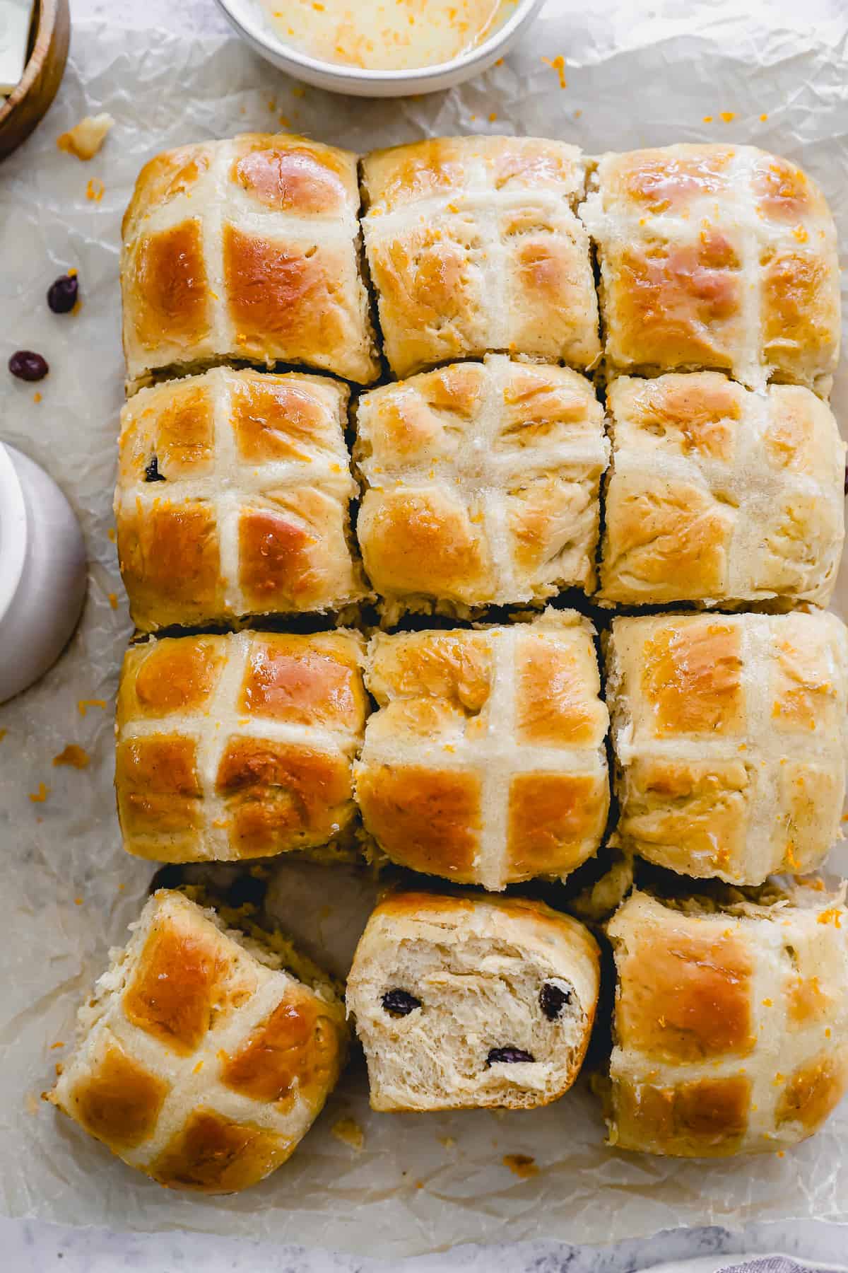 overhead view of hot cross buns, one turned on its side to show the texture.