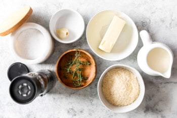 overhead view of ingredients for homemade alfredo sauce in individual bowls.