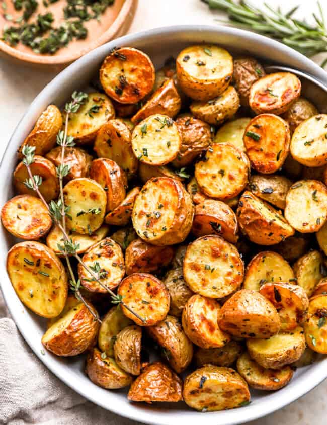 overhead view of roasted potatoes in a white bowl.