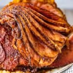 This Brown Sugar Pineapple Ham is the perfect Easter Ham recipe! We made a delicious cola and brown sugar glaze for ham, and combined it with crushed pineapples. This spiral ham is easy to make, and filled with SO much flavor!