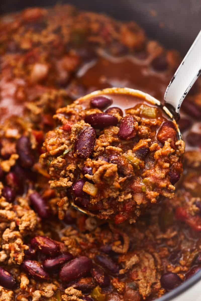 close up on a ladle full of beef and bean chili