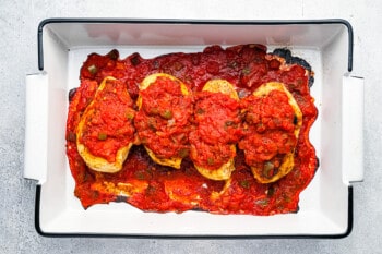 baked salsa chicken in a white rectangular baking pan.