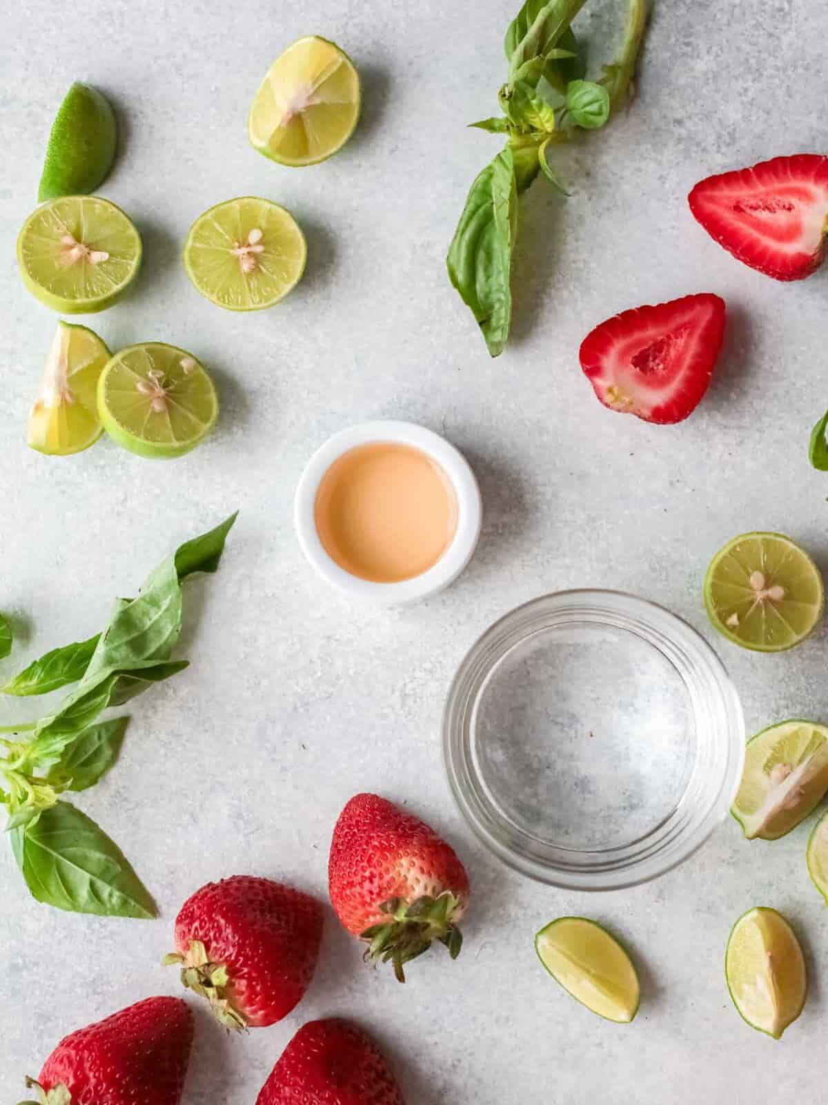 overhead view of ingredients for strawberry basil margarita.