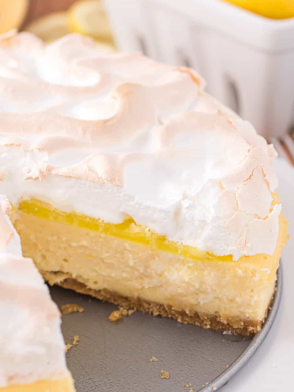 close up of a cut lemon curd cheesecake on the base of a springform pan.