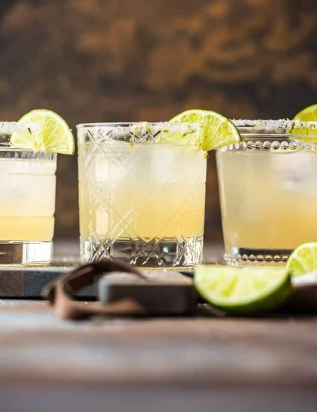 margaritas in glasses with lime garnish