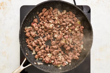 ground beef cooking in a pan.