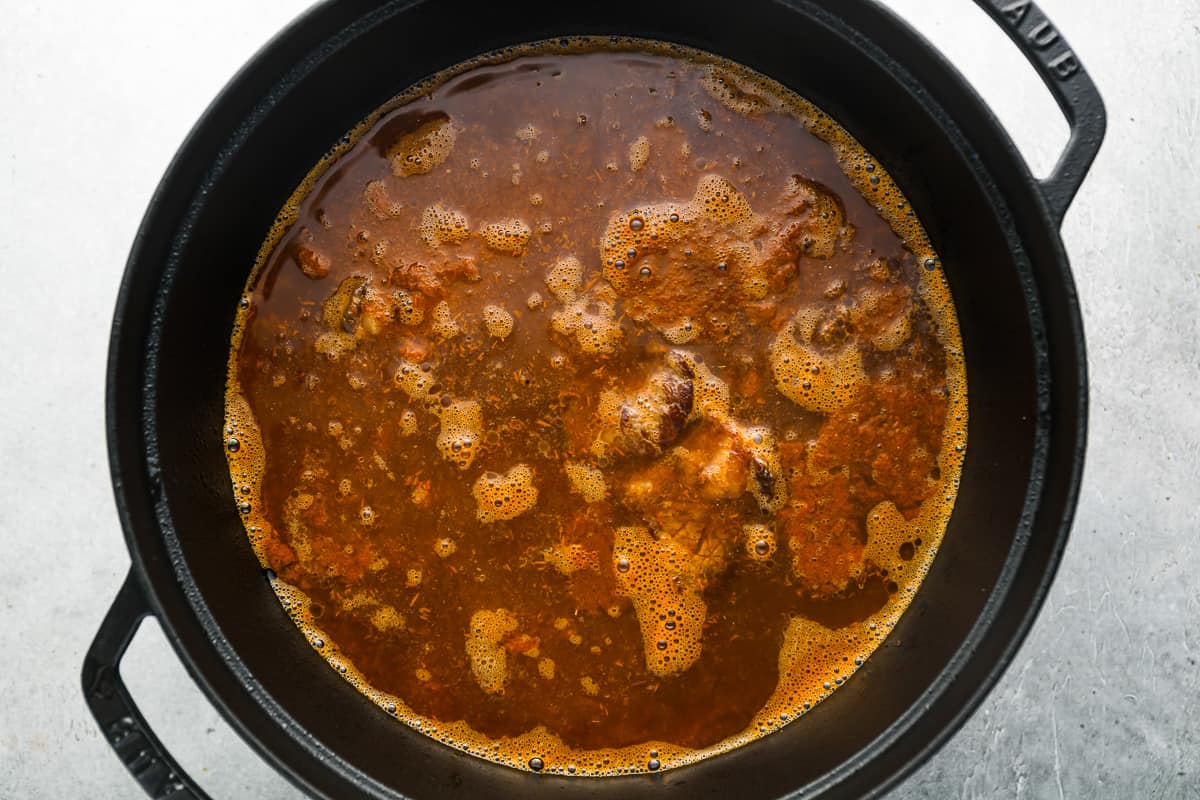 a pot of stew with meat in it on a table.