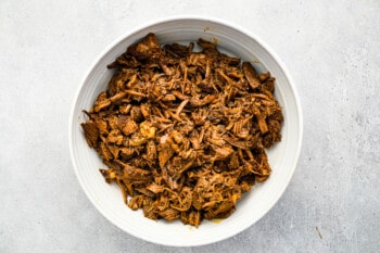 bbq pulled pork in a white bowl.