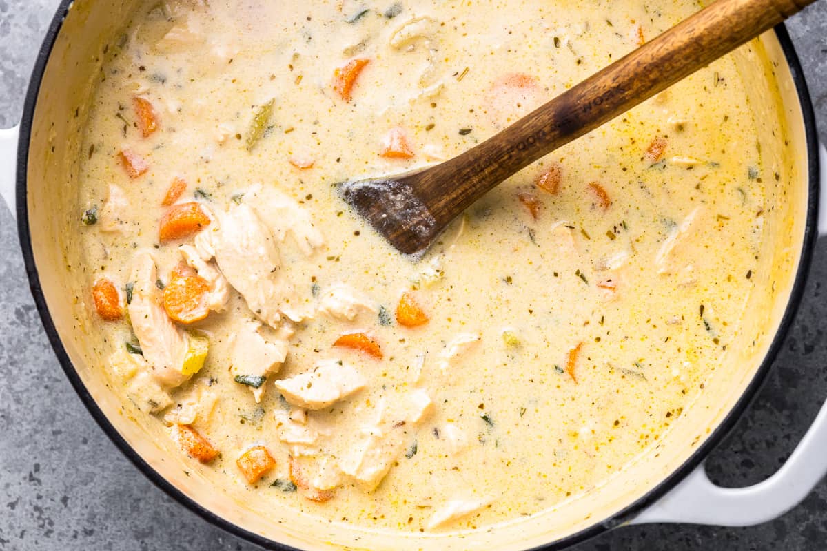 cream of chicken soup in a pot with a wooden spoon.