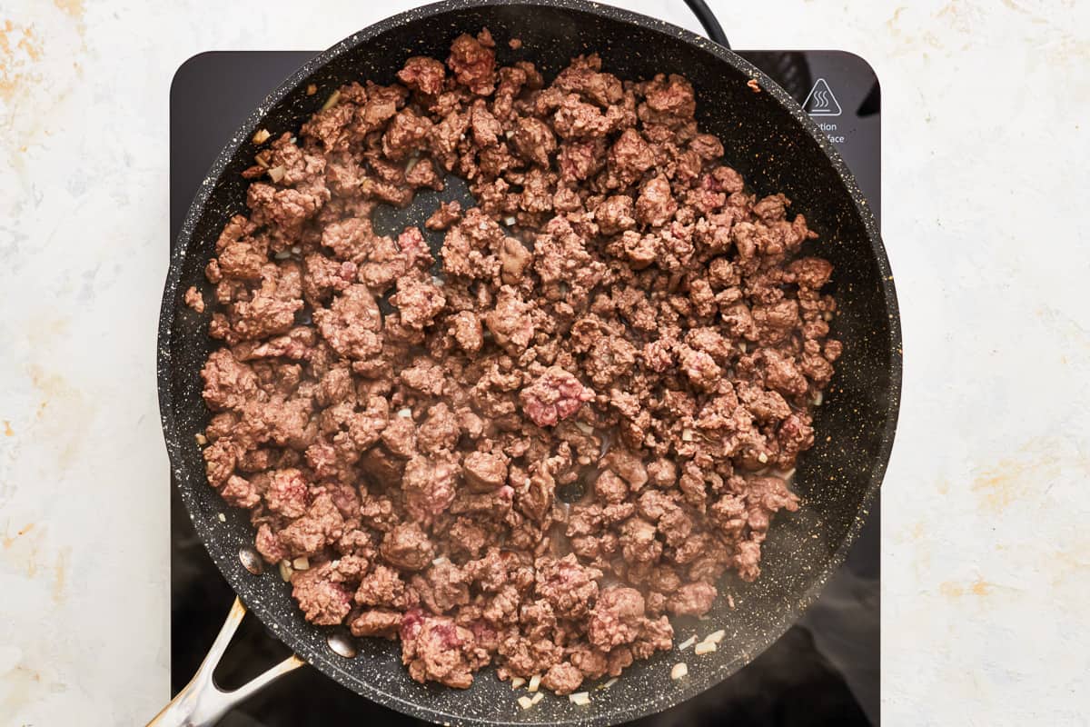 ground beef cooking in a frying pan.