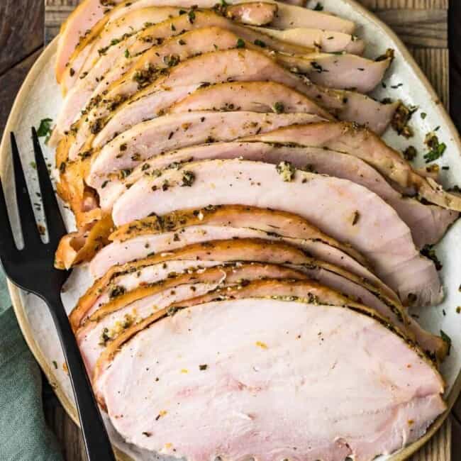 juicy smoked sliced turkey breast on a cutting board