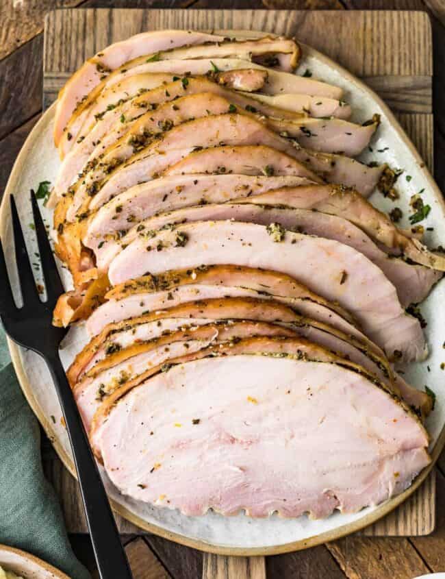 juicy smoked sliced turkey breast on a cutting board