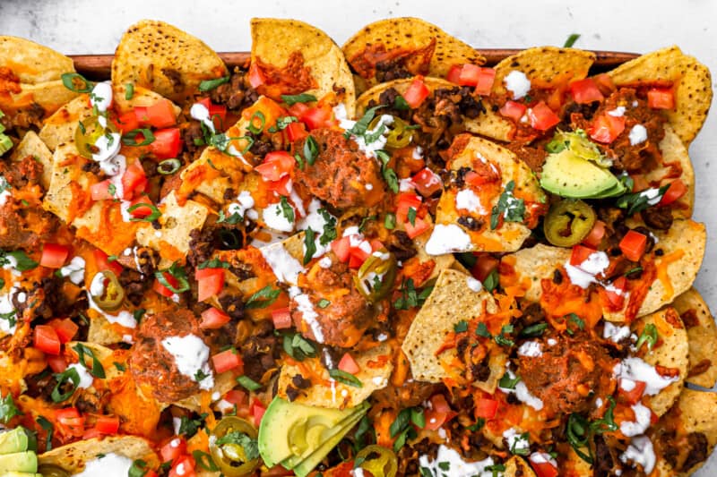 overhead view of nachos supreme on a baking sheet.