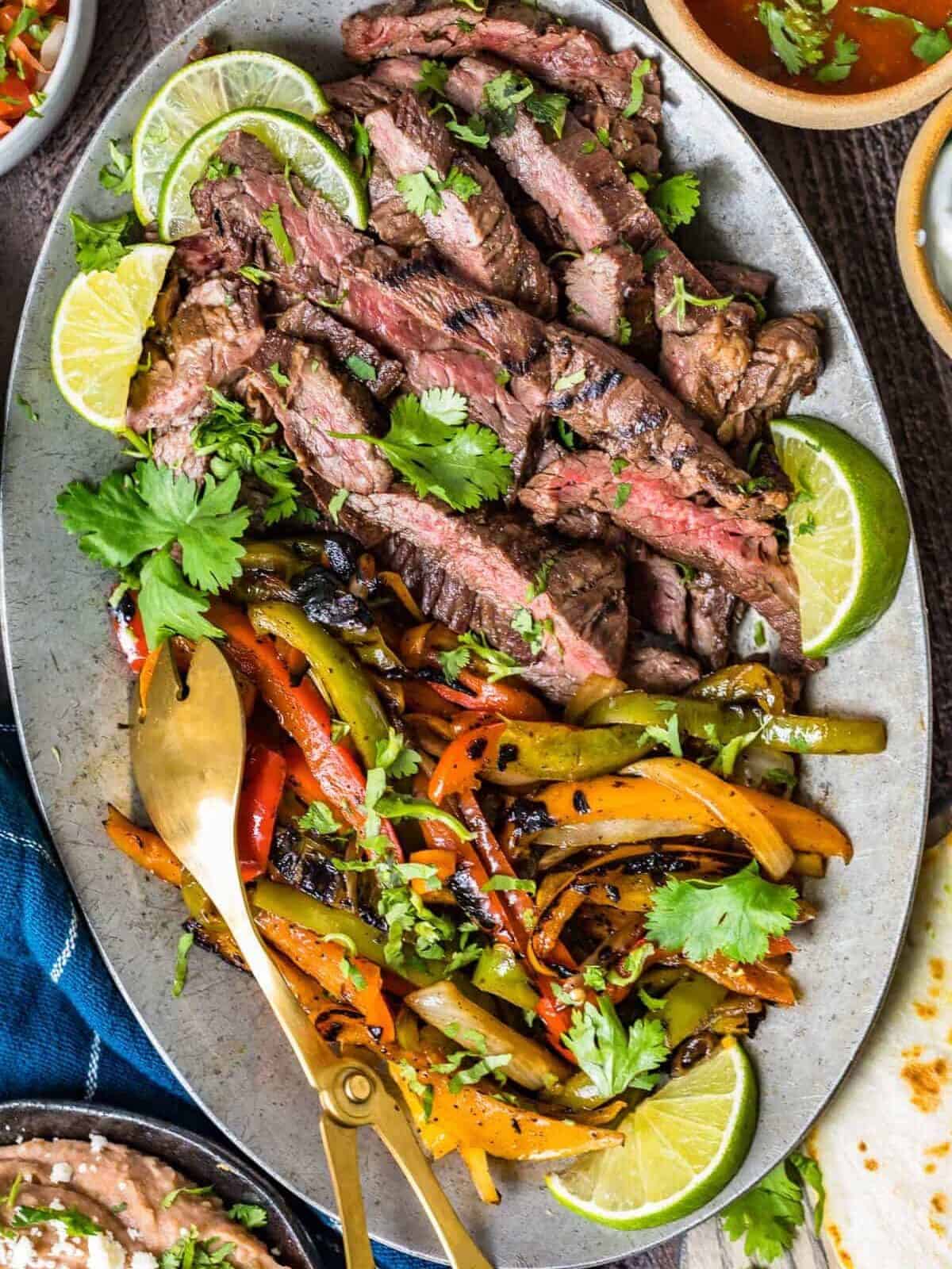 overhead view of a platter of grilled steak fajitas