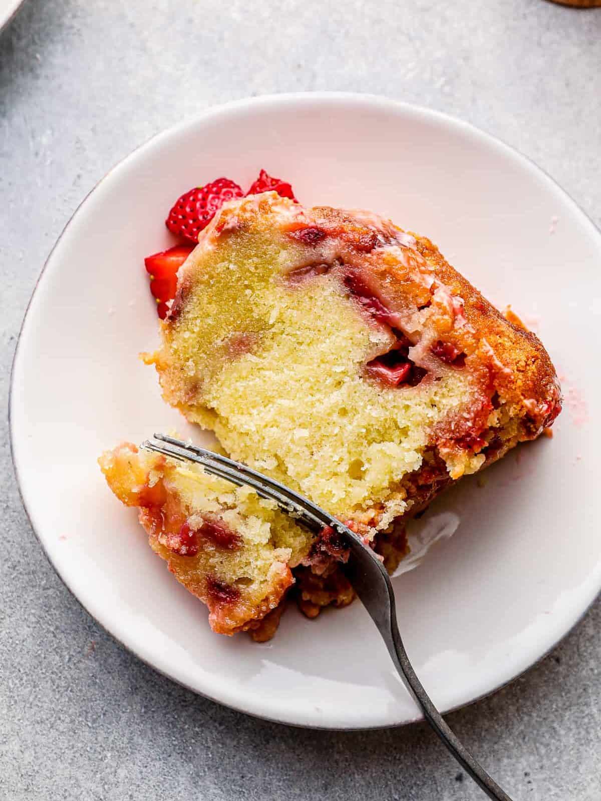 slice of glazed strawberry pound cake with silver fork