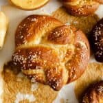 overhead view of homemade pretzels next to a cup of cheese sauce.