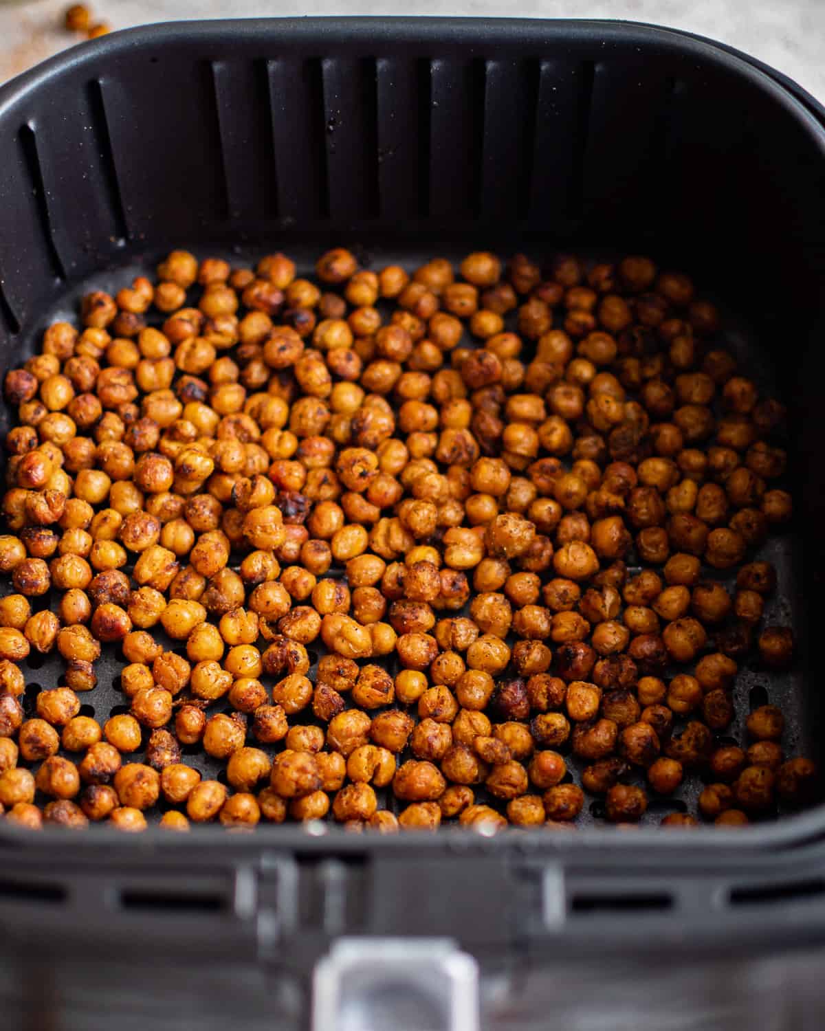 crispy chickpeas in an air fryer basket.