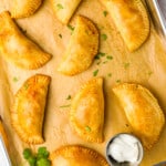 mexican empanadas on a baking sheet.