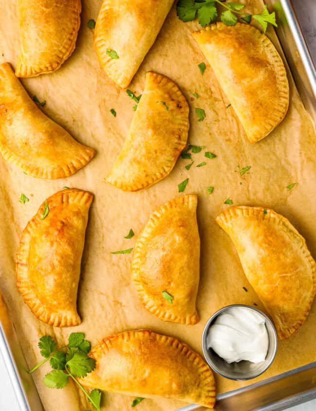 mexican empanadas on a baking sheet.