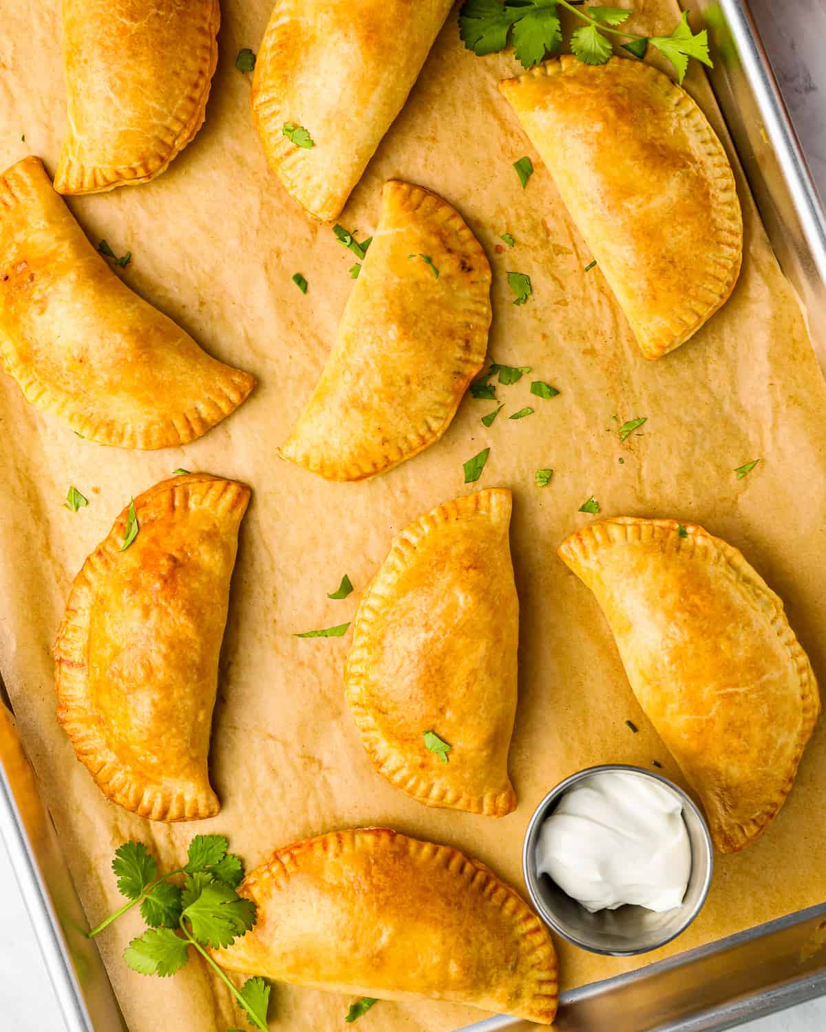 mexican empanadas on a baking sheet.