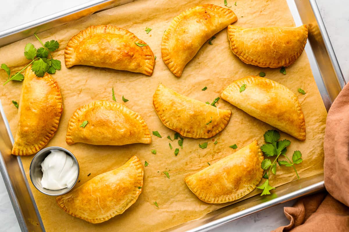 mexican empanadas on a baking sheet.