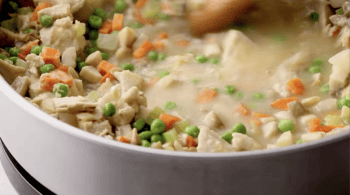 saucy chicken pot pie filling in a pan.