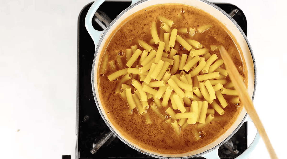 A pot of chili mac on top of a stove.