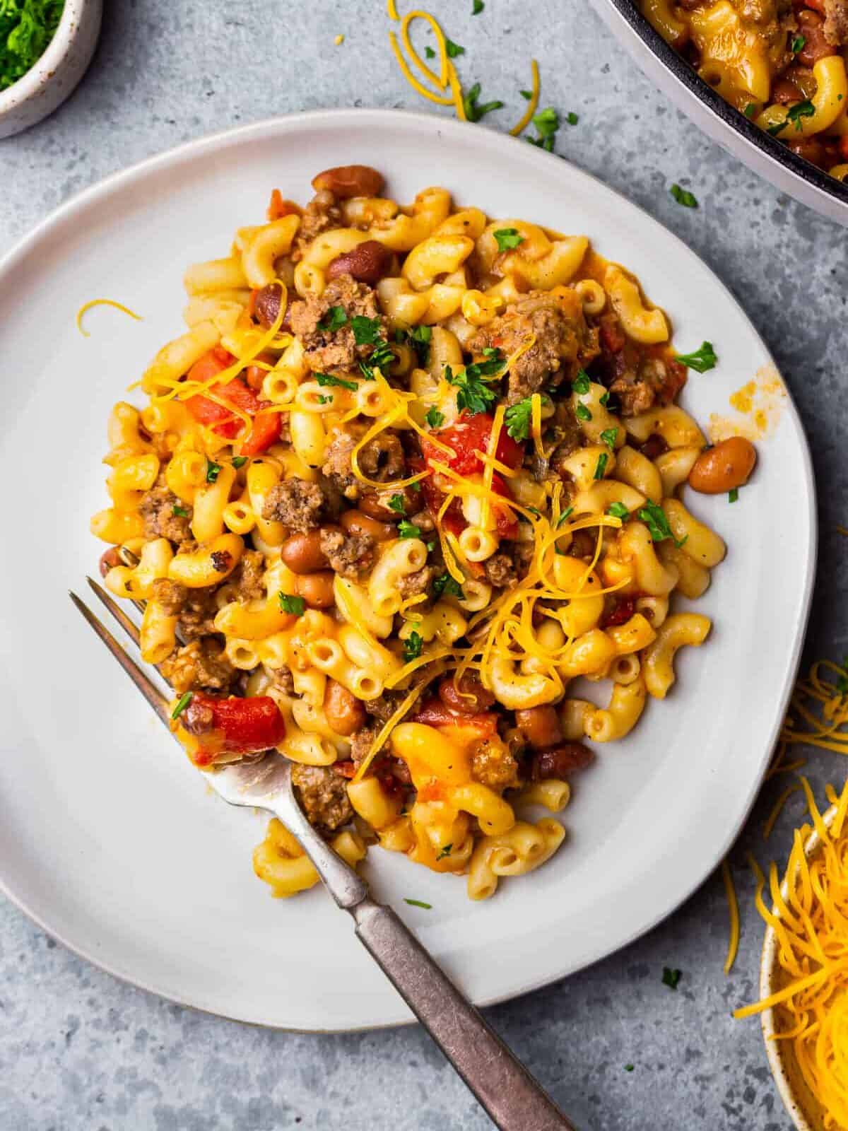 a plate of chili mac and cheese with a fork