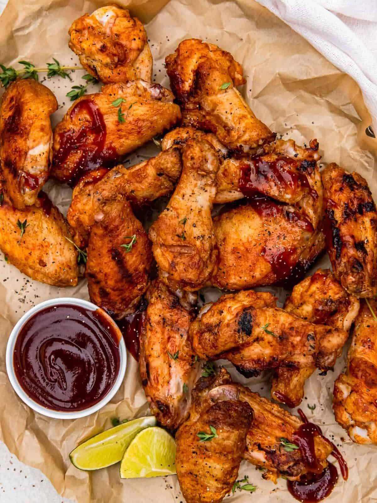 grilled chicken wings with dipping sauce in a small bowl