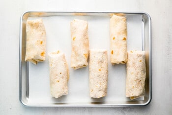 a tray of tortillas on a white surface.