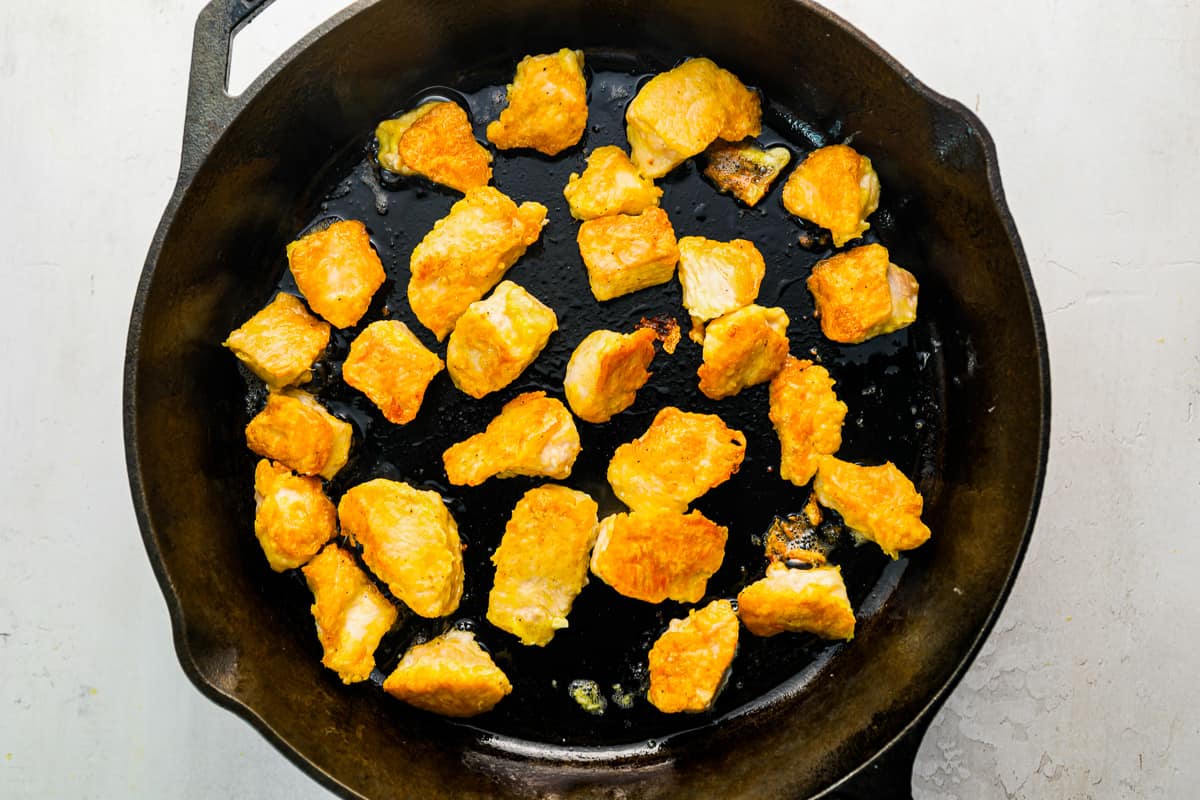 fried chicken in a cast iron skillet.