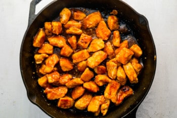 fried chicken in a skillet on a white background.