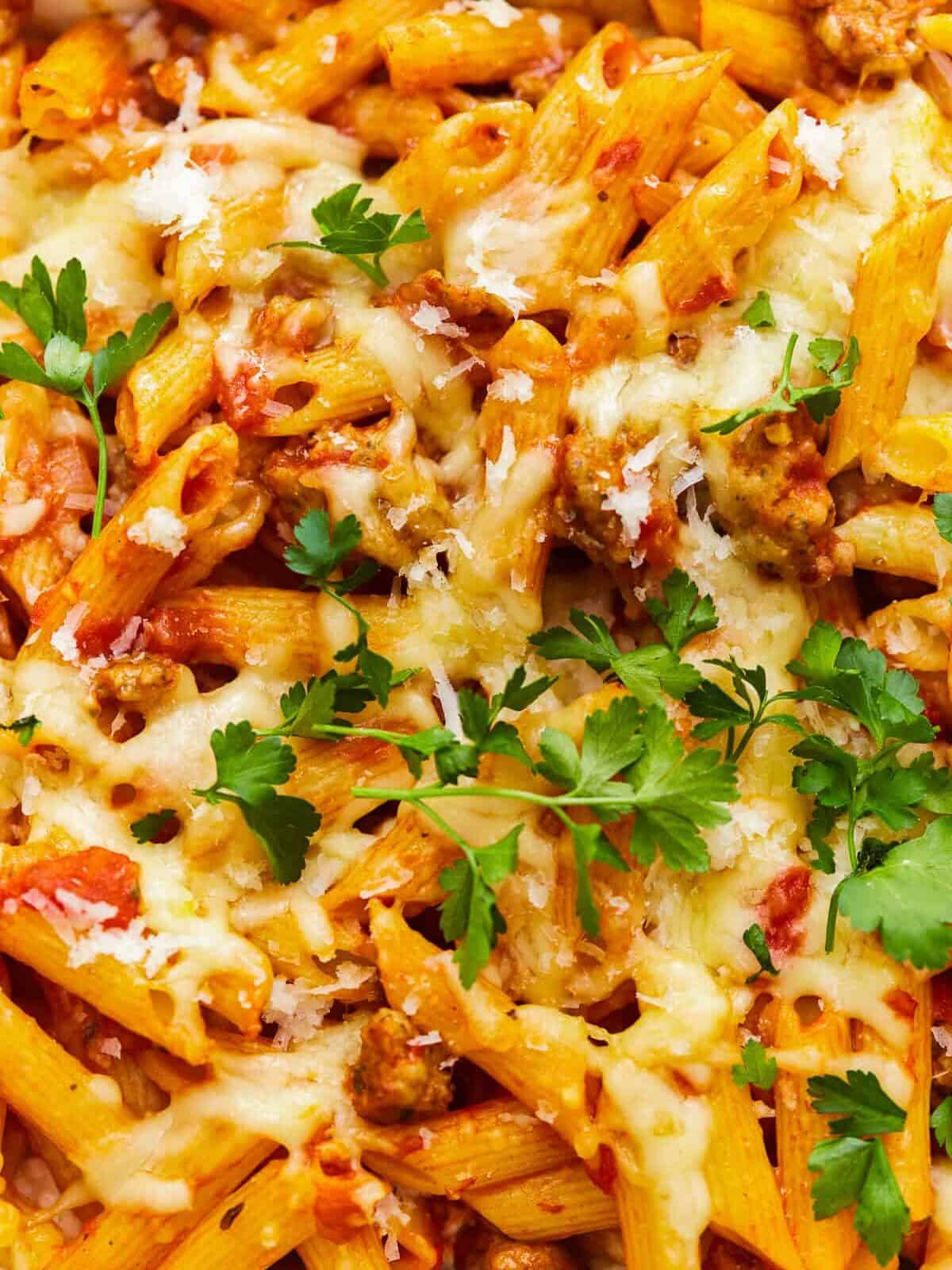 close up on cheesy mostaccioli with meat sauce