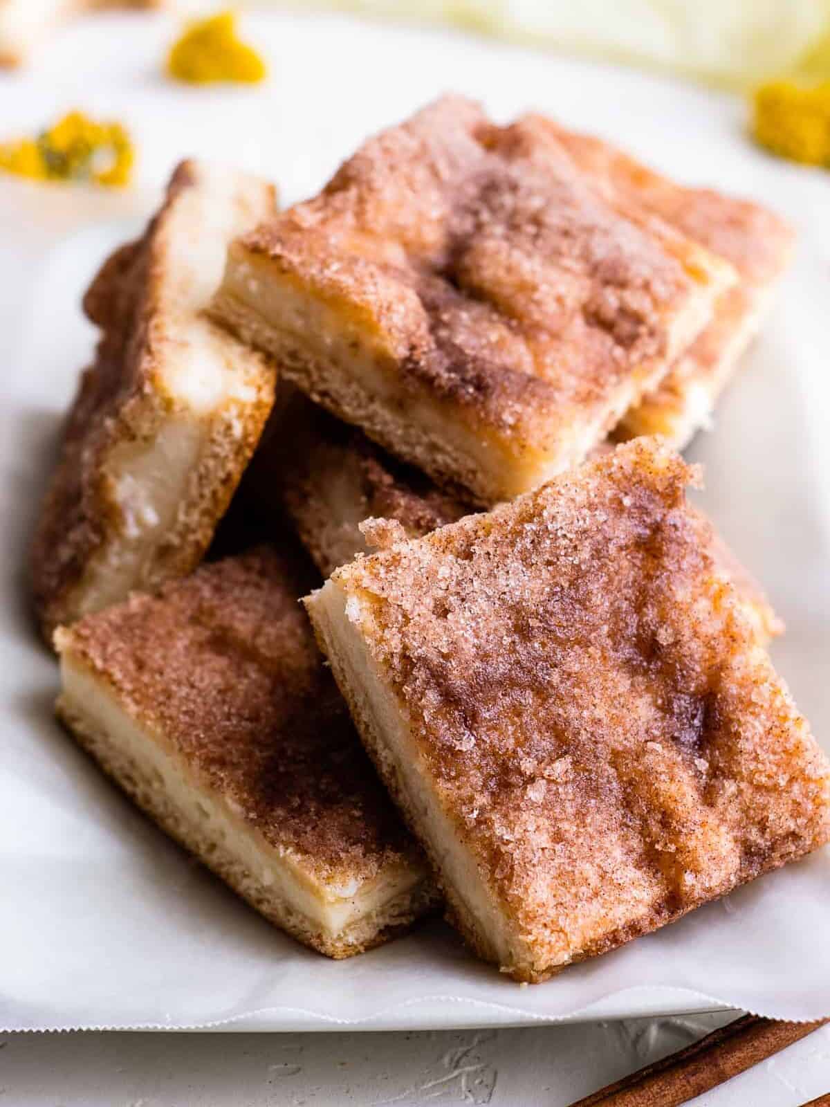 sopapilla cheesecake bars cut on platter