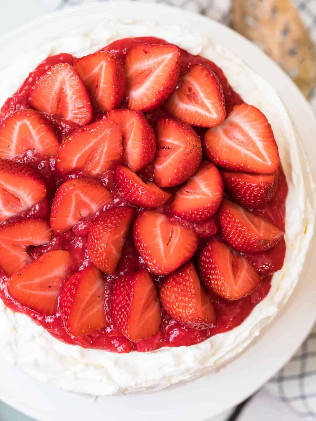 strawberries topping white layer cake