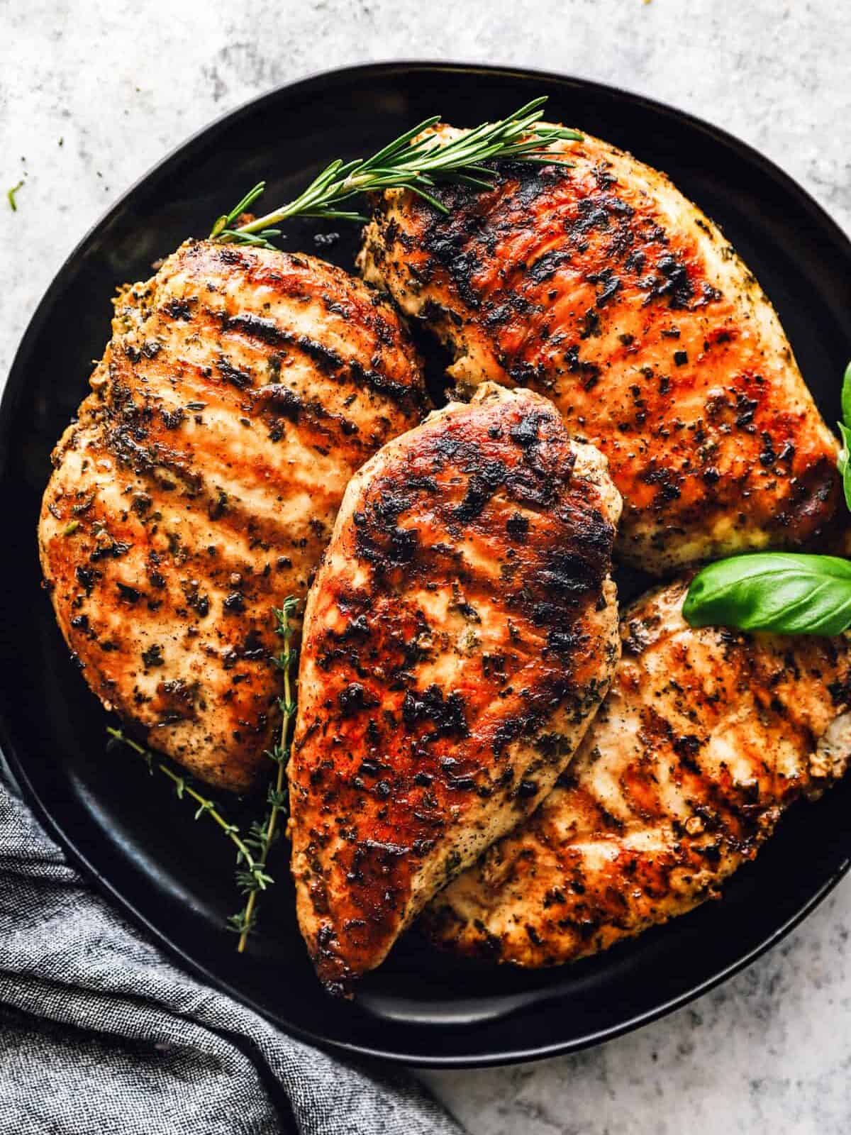 a plate of garlic herb grilled chicken breasts