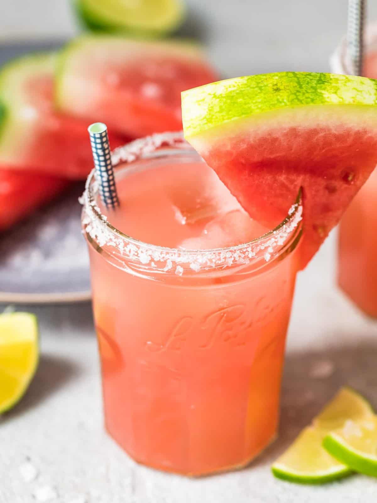 a watermelon margarita in a jar glass