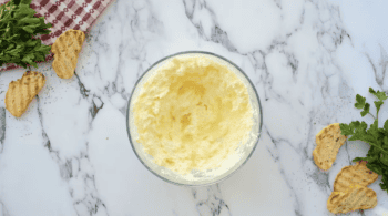 beaten butter and cream cheese in a glass bowl.