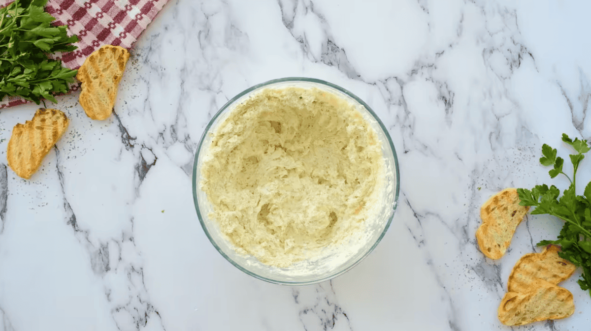 homemade boursin cheese in a glass bowl.