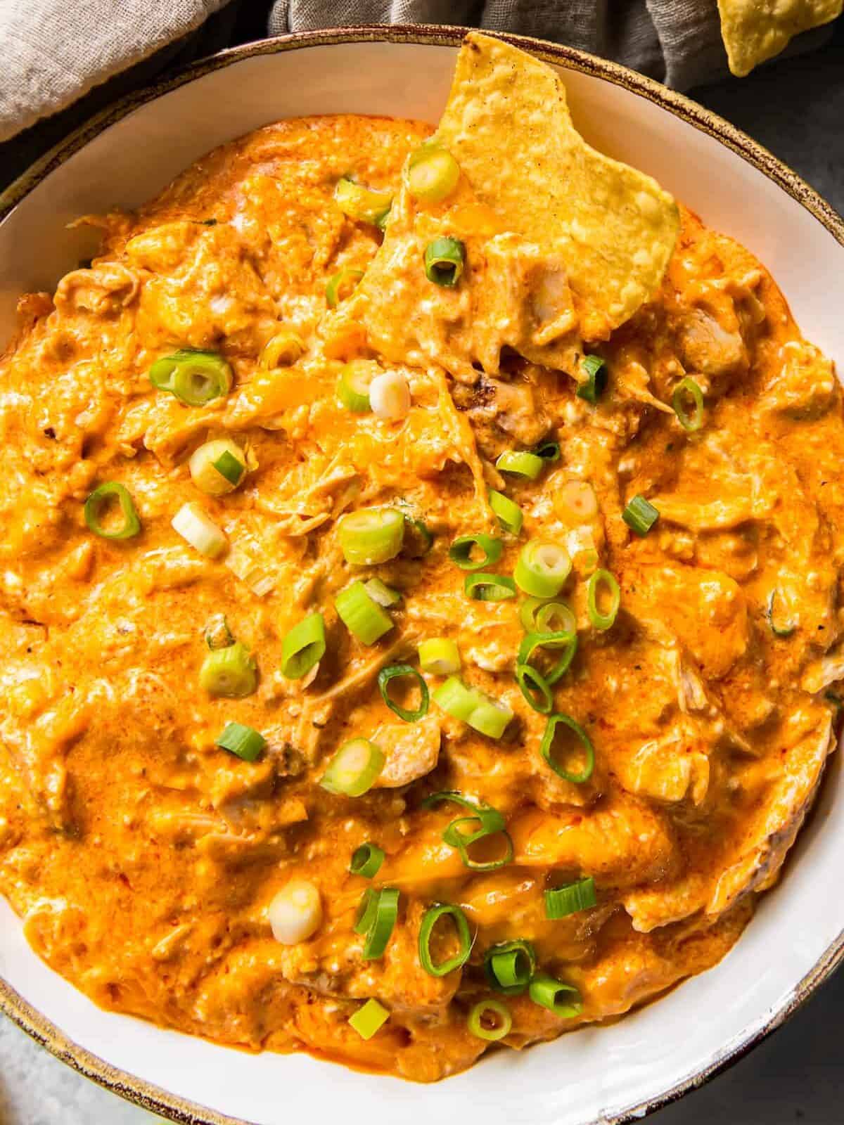 up close white bowl with crockpot buffalo chicken dip