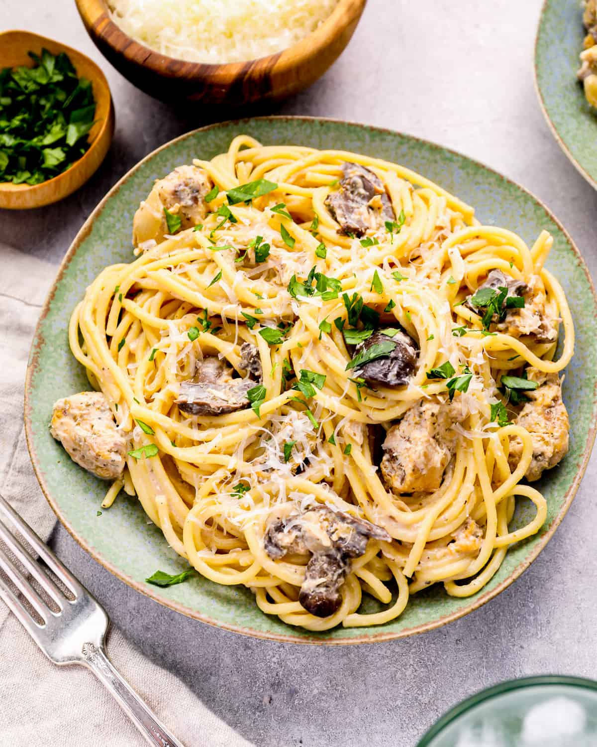 a plate of crockpot chicken tetrazzini with mushrooms and parmesan cheese.