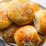 sesame buns with sesame seeds on a plate.