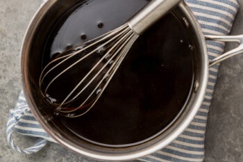 teriyaki sauce in a saucepan with a whisk.