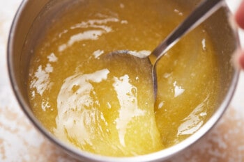 lemon and butter mixed together in a stainless bowl.