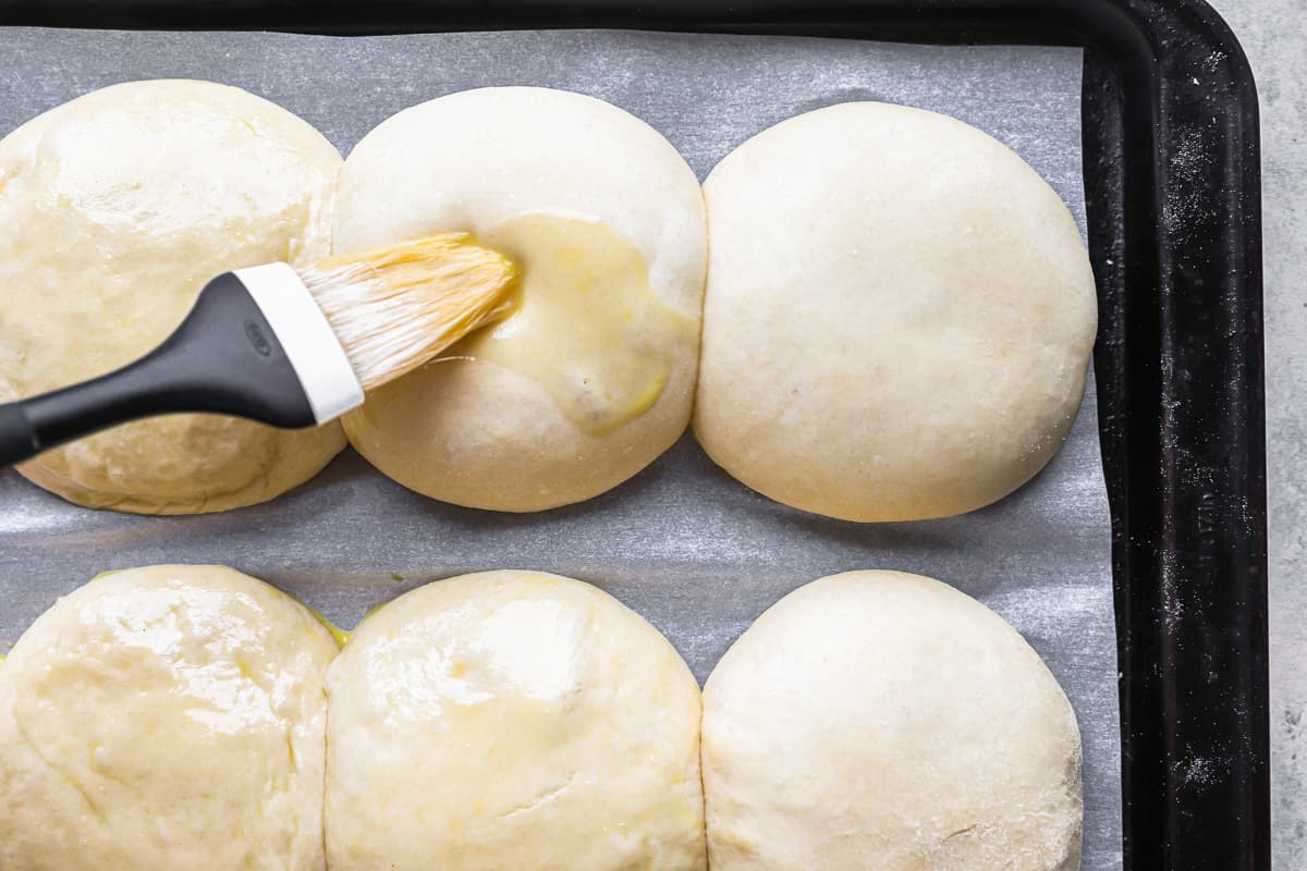 a brush is used to brush butter on a baking sheet.