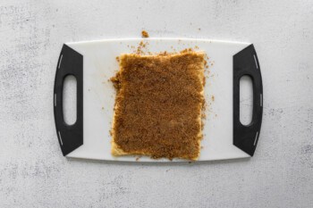 cinnamon filling spread over crescent dough on a plastic cutting board.