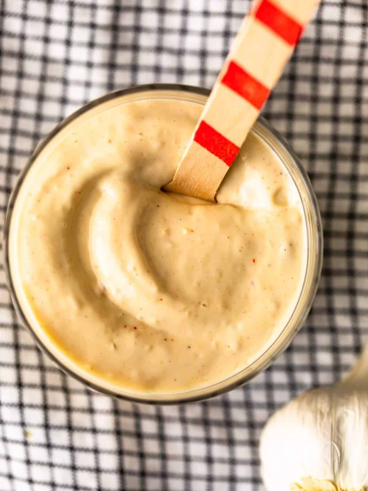 overhead view of a small container of garlic aioli