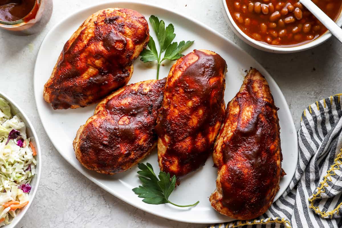 bbq smoked chicken breasts on a plate.